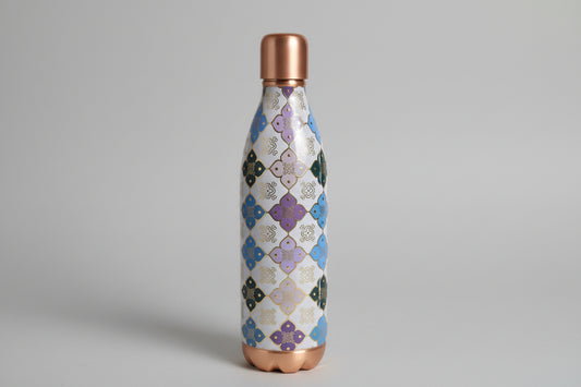 Decorative water bottle with geometric pattern on a tiled background