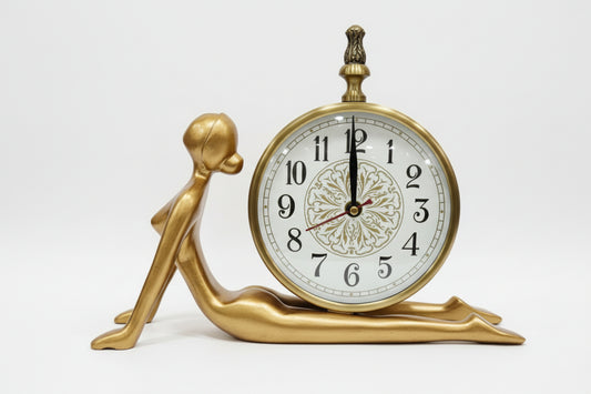 Decorative clock with a black figurine base on a white background